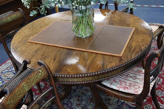 An early 19th century rosewood and brass inlaid breakfast table, Diam. 4ft